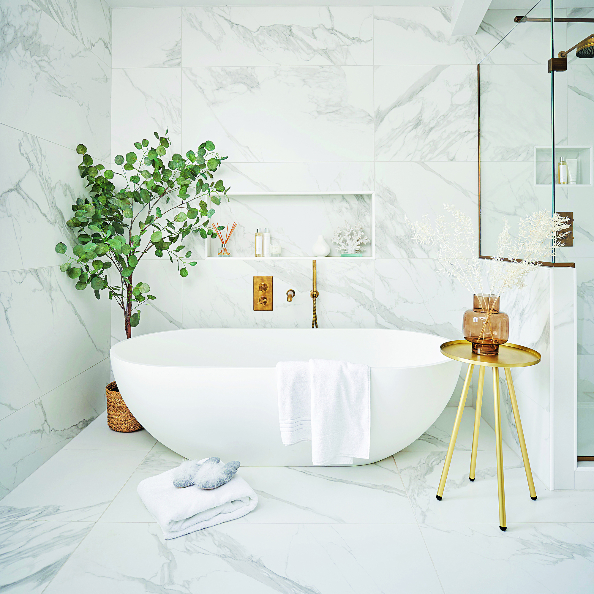 White bathroom with freestanding bath and plant
