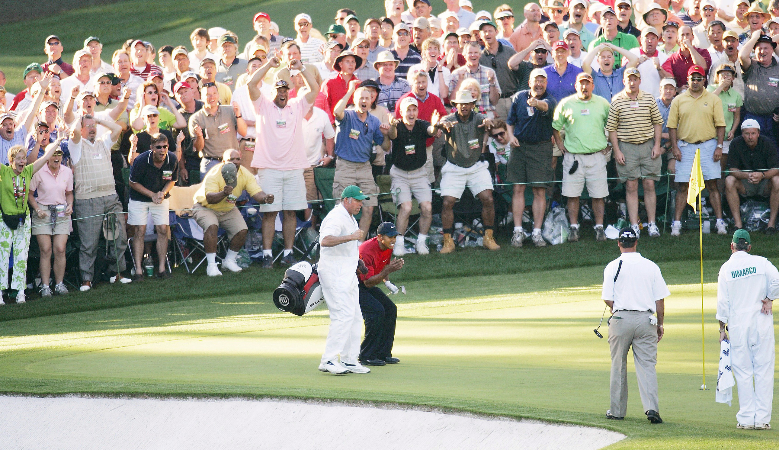 Tiger Woods and his caddie react to a chip at the 16th hole at Augusta National