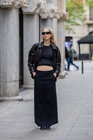 woman in black maxi skirt and leather jacket