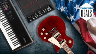 A guitar, keyboard, and samplepad on the floor with an American flag