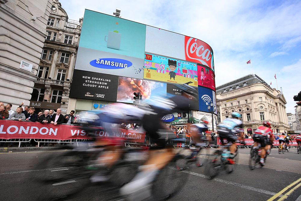 The peloton blasts by Piccadilly Circus