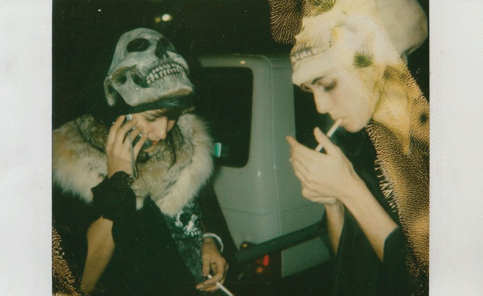 two women, one lighting a cigarette
