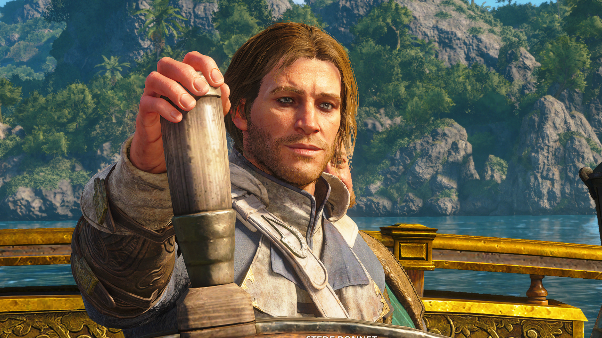 Black Flag legendary ships: A close-up of Edward Kenway smirking with one hand on the Jackdaw's wheel.