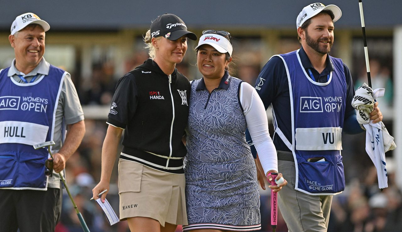 Charley Hull and Lilia Vu hug on the 18th green