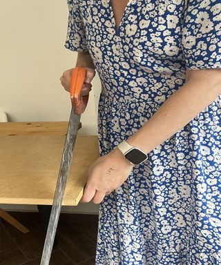 woman cutting wood with hand saw