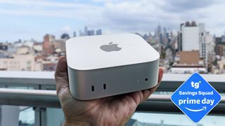 An Apple Mac mini M6 in hand with a Tom's Guide Prime Day deals badge