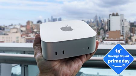 An Apple Mac mini M6 in hand with a Tom's Guide Prime Day deals badge