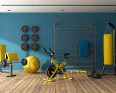 how to clean gym equipment yellow gym equipment in a blue wall basement home gym - getty