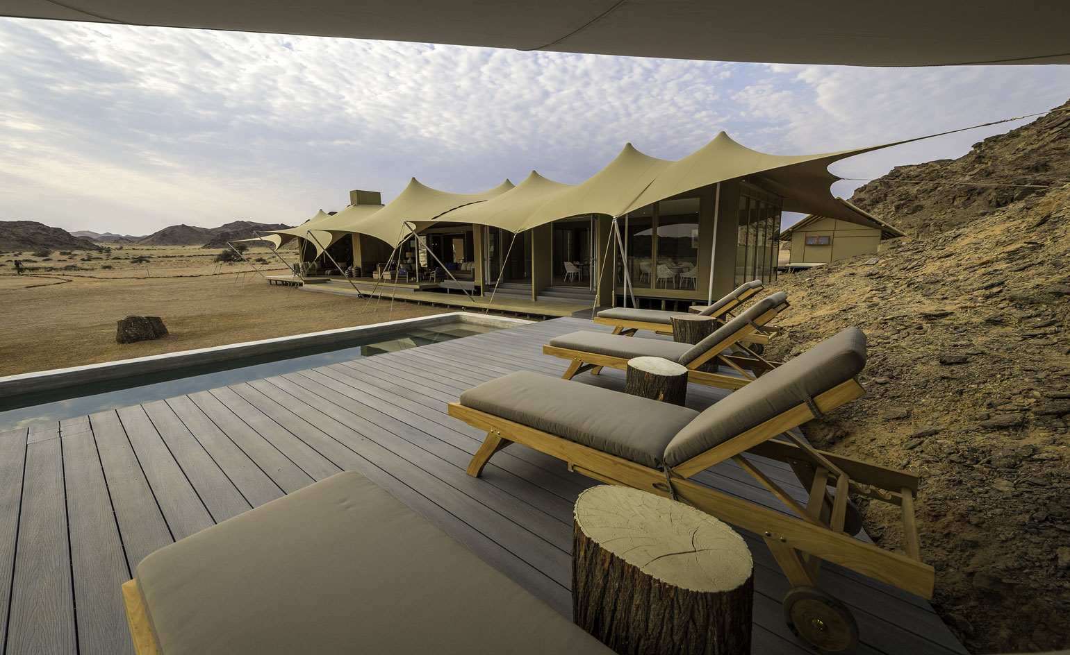 Sun loungers in front of pool