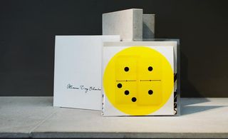 Bright yellow dice design on paper