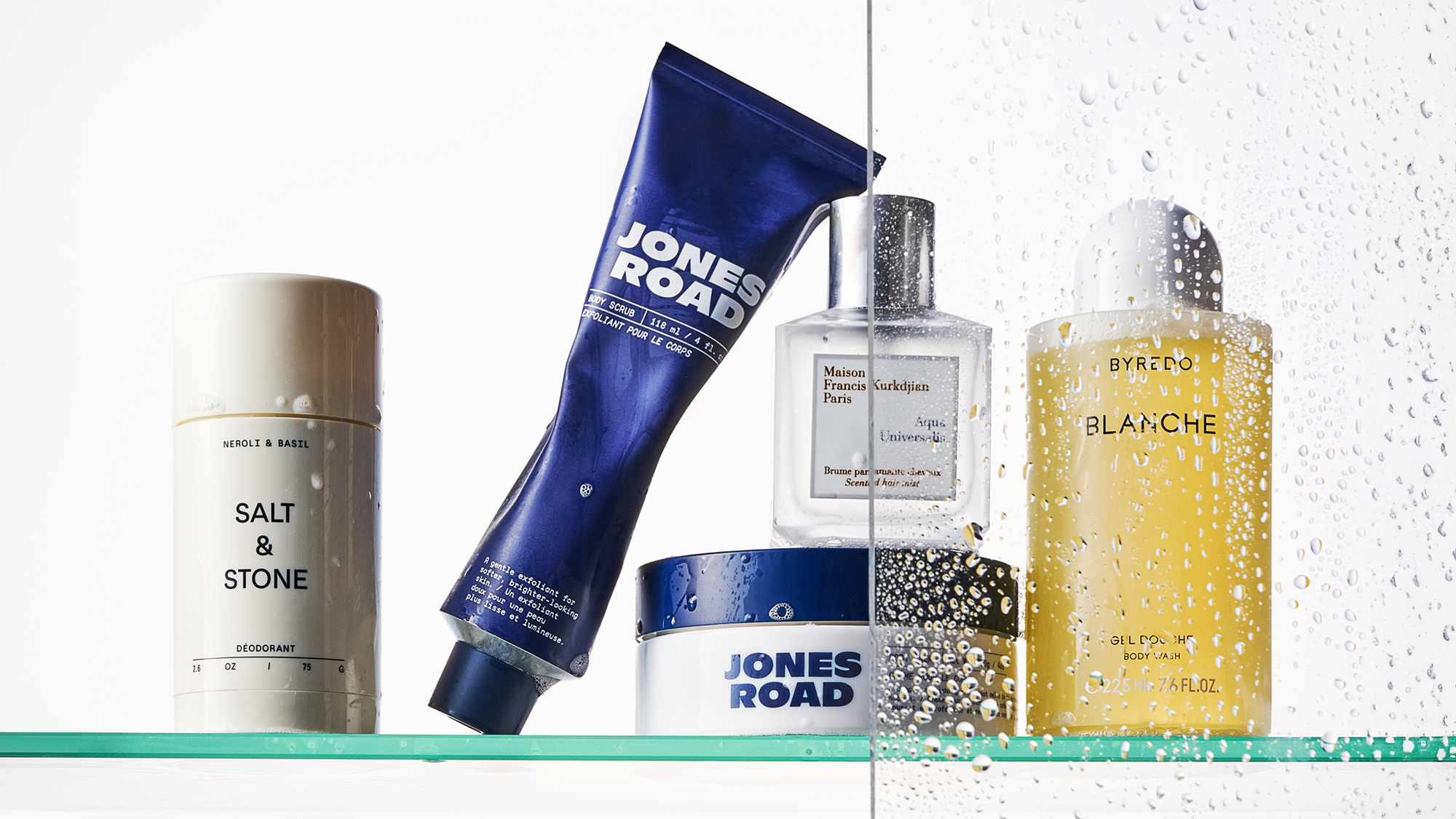 A picture of body products on a shower shelf