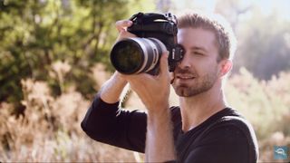 Image of a photographer using a professional camera