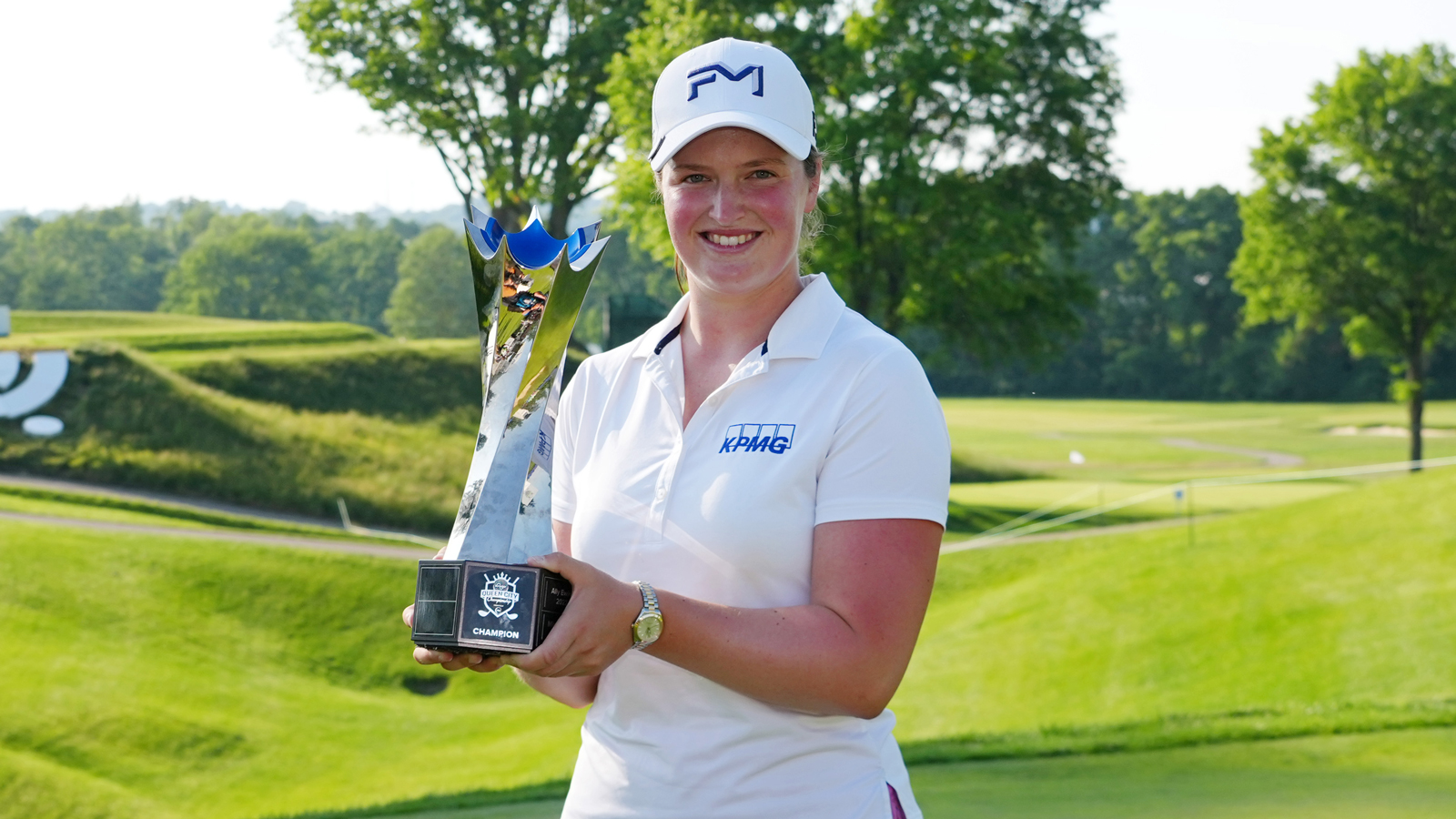 Lottie Woad holds a trophy