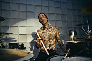 Travis Barker shirtless behind his drum kit