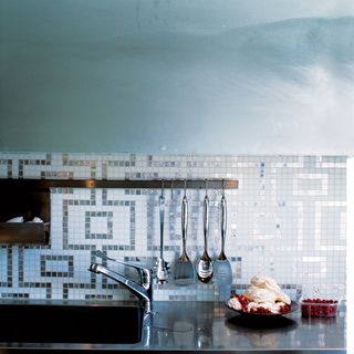 kitchen with mosaic tiles and faucet