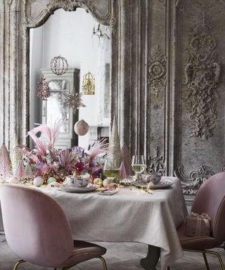 A pastel pink dining room scheme with ornate wall arch decor