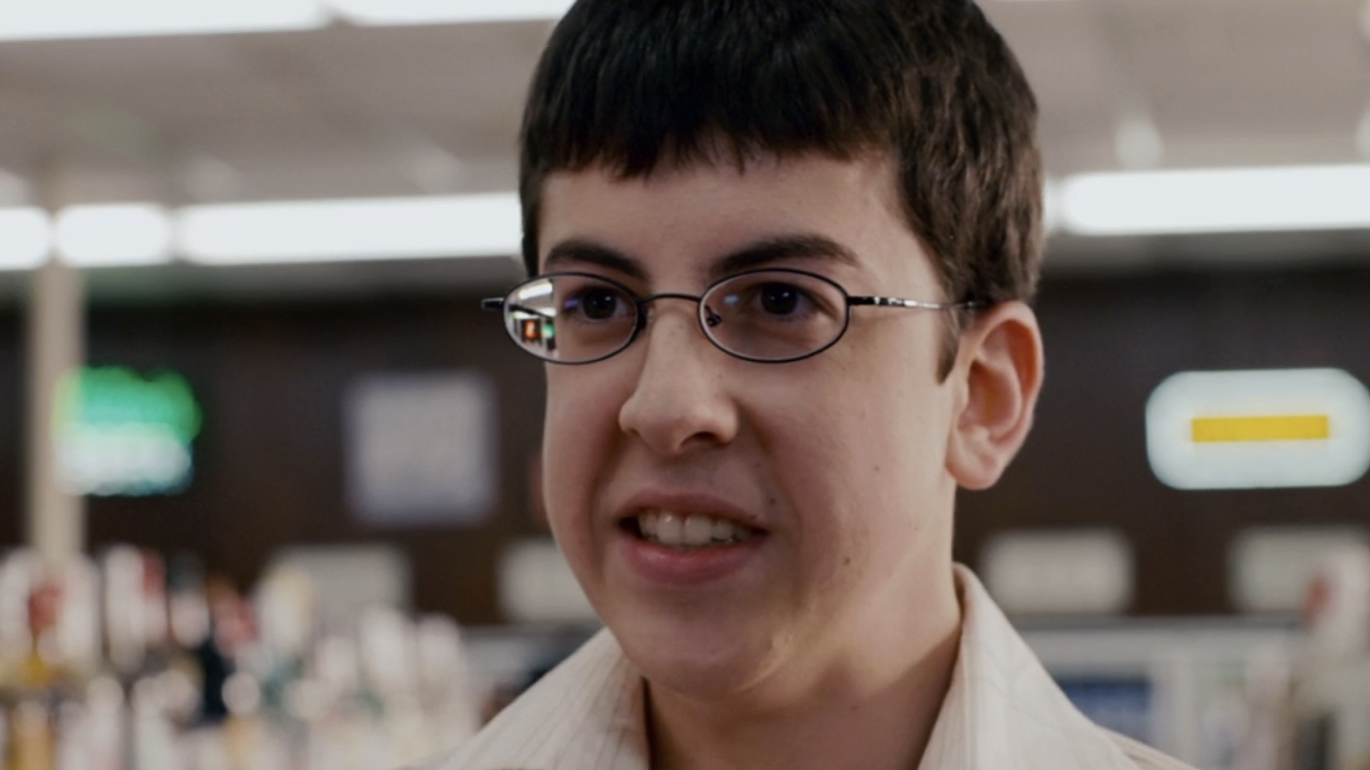 McLovin smiling at Mindy inside convenience store while buying beer in Superbad