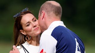 Catherine, Duchess of Cambridge kisses Prince William, Duke of Cambridge during the prize-giving of the Out-Sourcing Inc. Royal Charity Polo Cup at Guards Polo Club, Flemish Farm on July 6, 2022 in Windsor, England.