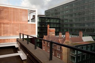 Roof terrace with black bars and a view of neighbouring buildings