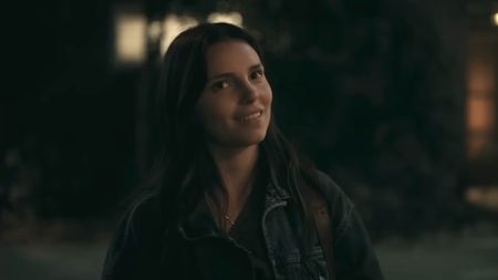 Nikki smiling outside in Obsession.