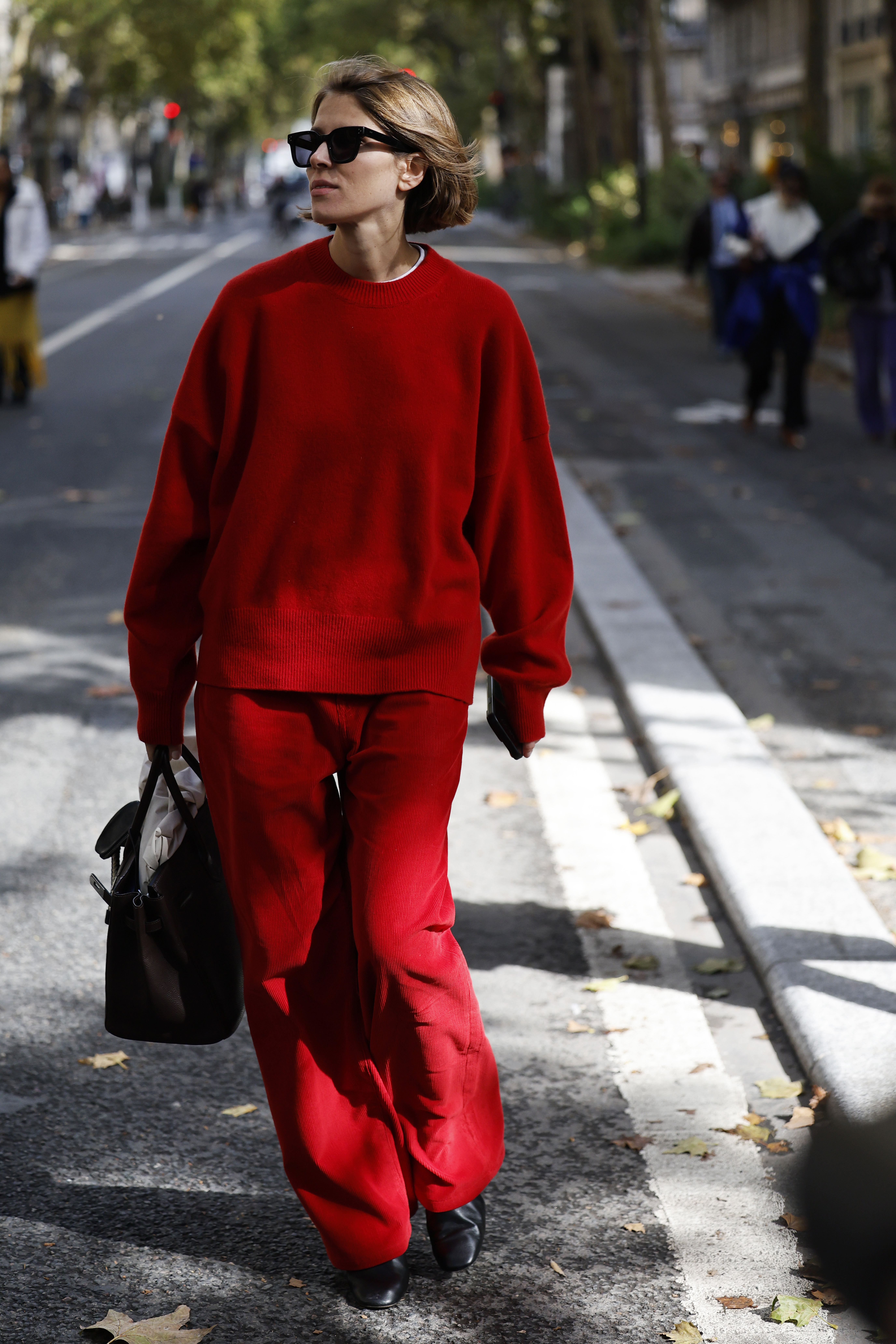 PARIS, FRANCE - OCTOBER 04: A guest wears red jumper, red trousers, brown Herm&amp;egrave;s bag, outside Herm&amp;egrave;s, during the Womenswear Spring Summer 2026 as part of Paris Fashion Week on October 04, 2025 in Paris, France. (Photo by Claudio Lavenia/Getty Images)