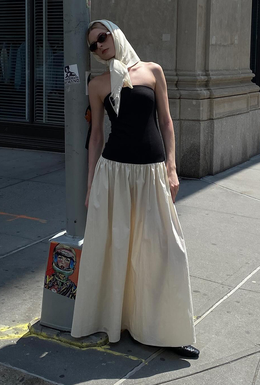 a photo of a woman's white dress outfit with a two-tone black and white strapless dress styled with black ballet flats and a white scarf