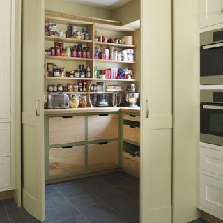 kitchen pantry with tiled flooring and kitchen shelves