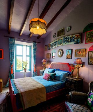 bedroom with purple walls and blue bedding