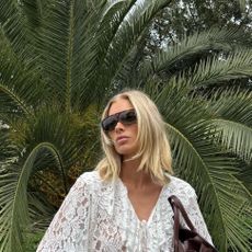 Elsa Hosk wearing a white lace ruffled blouse