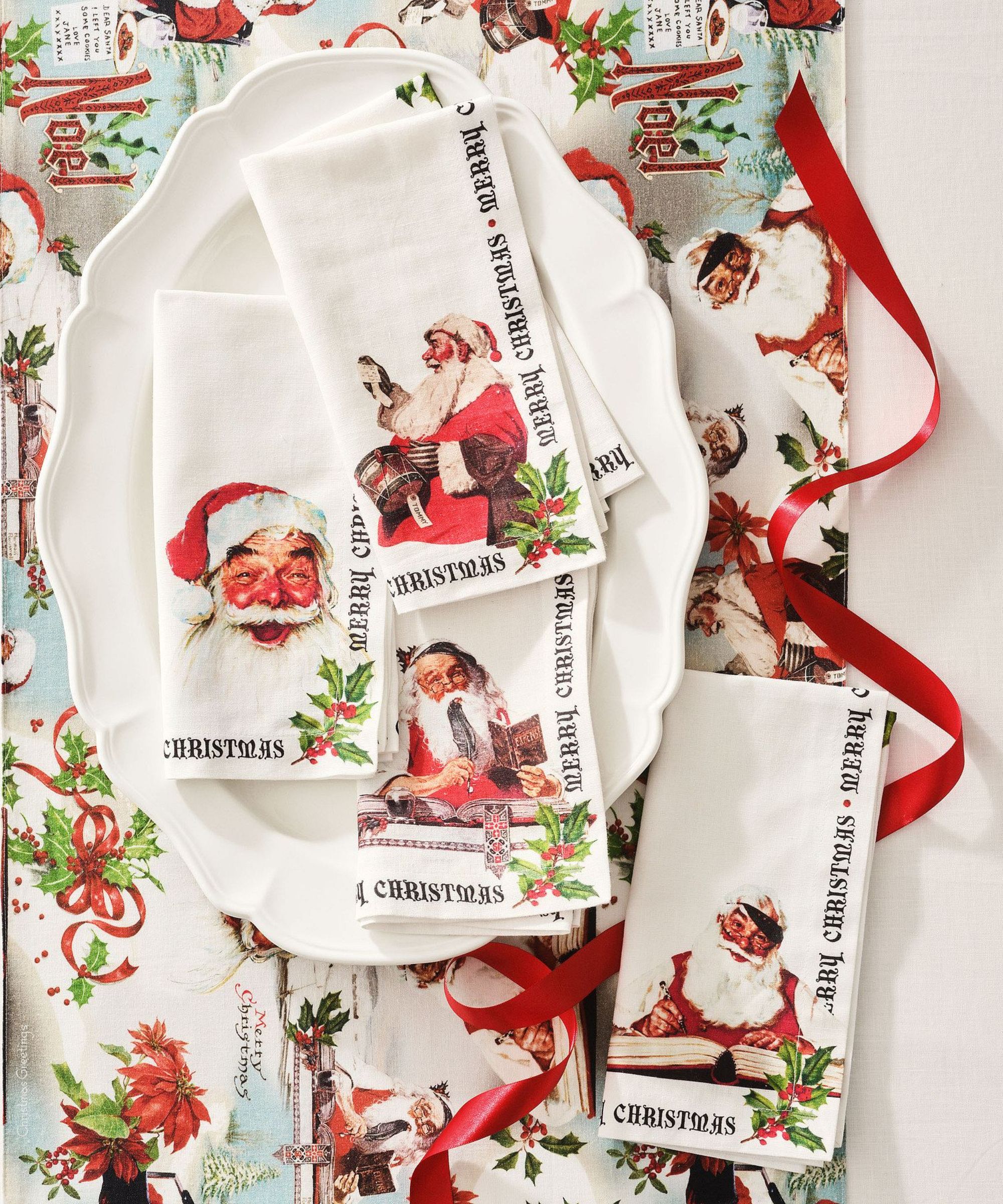 White scalloped platter on festive runner with Norman Rockwell Christmas napkins