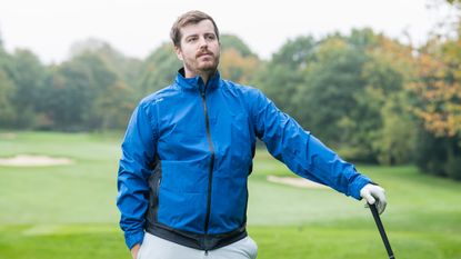 Golfer poses wearing the Ping SensorDry 2.5 Graphene Jacket