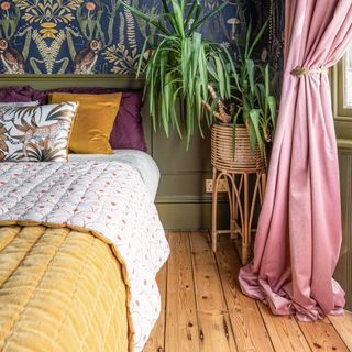 Bedroo with wooden floor, pink curtains, green wall and wallpaper