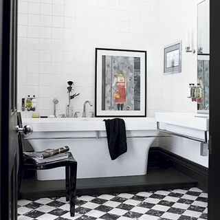 Bathroom with bathtub with white tiles on wall
