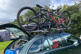 The Thule Fastride bike mount rack being used on the roof of a very packed car