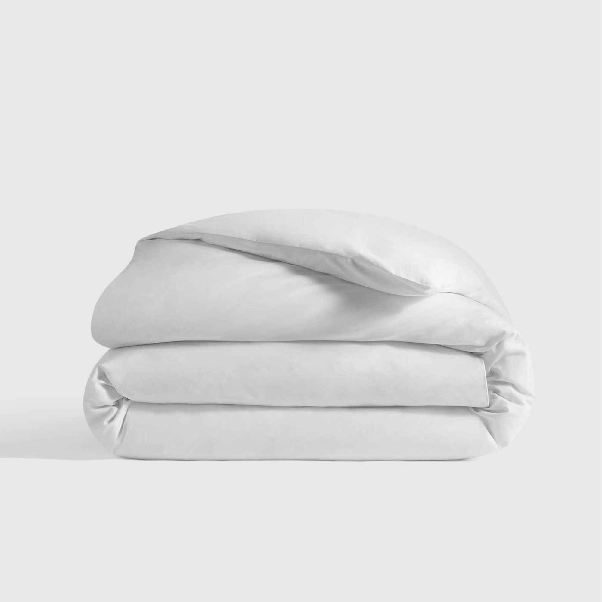 Quince classic percale duvet cover on a folded duvet against a white background