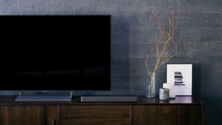 the sony ht-mt300 soundbar next to a TV