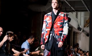 Male model at Paris fashion week wearing red Yohji Yamamoto jacket 2018