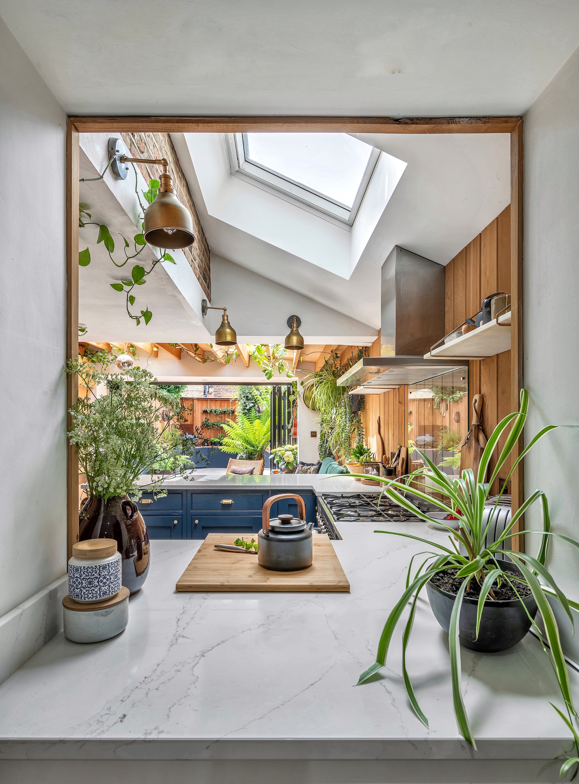 A view through to the kitchen and living space, showing all the natural light coming through from the skylight above the kitchen space.