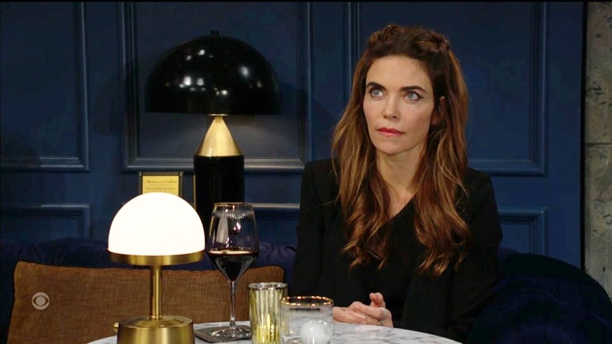 Amelia Heinle as Victoria sitting at a dining table in The Young and the Restless