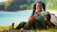 Cirie sits by a rock with a gorgeous view of Fiji in the background for a confessional on Survivor.