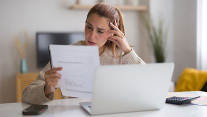 A woman looking over her electric bill