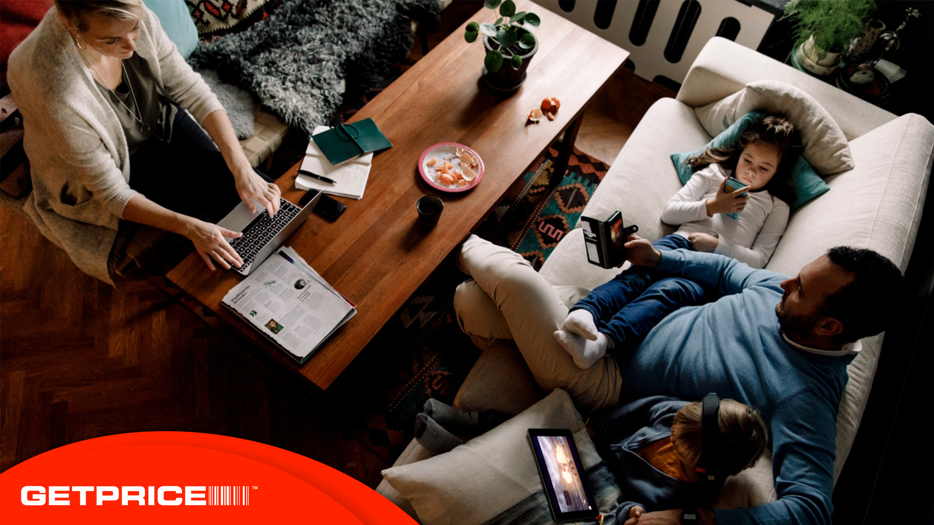 a family sitting around using various technologies