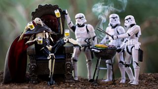Star Wars action figures with General Grievous sitting and Stormtroopers grilling and toasting with drinks outdoors