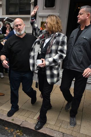 Johnny Depp being escorted from hotel on way to Jeff Beck show.