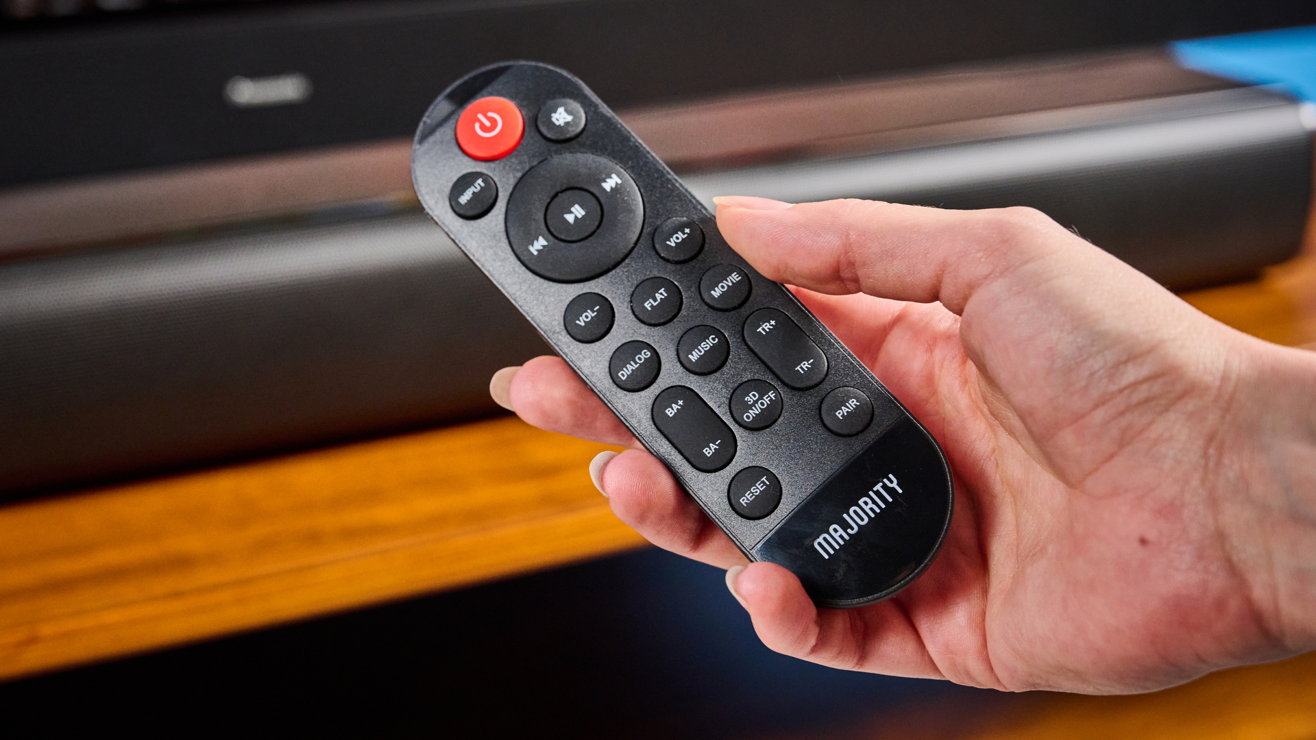 the budget majority naga 60 soundbar in black, showing its buttons and remote