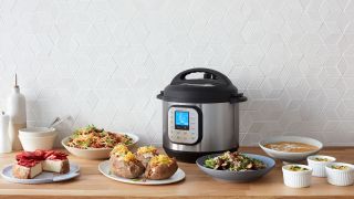 Instant Pot Duo Nova on a kitchen countertop surrounded by dishes prepared in the multi-cooker