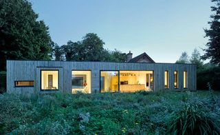 Modern CLT extension to listed barn