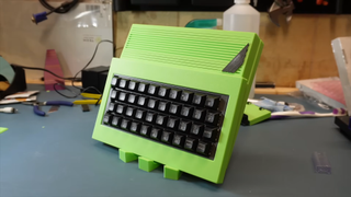 A custom built, lime green ZX Spectrum rests on a 3D printed stand of the same striking shade.