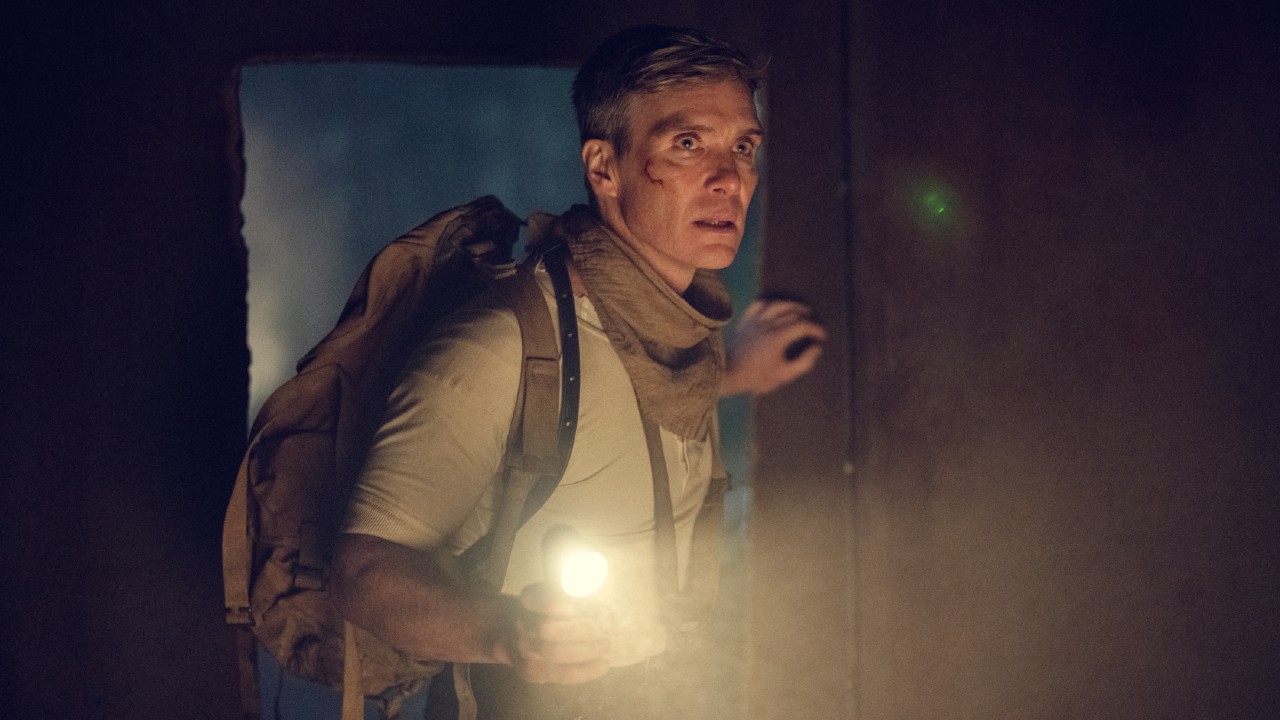 Cillian Murphy as Tommy Shelby holding up a flashlight with his left hand in Peaky Blinders: The Immortal Man.