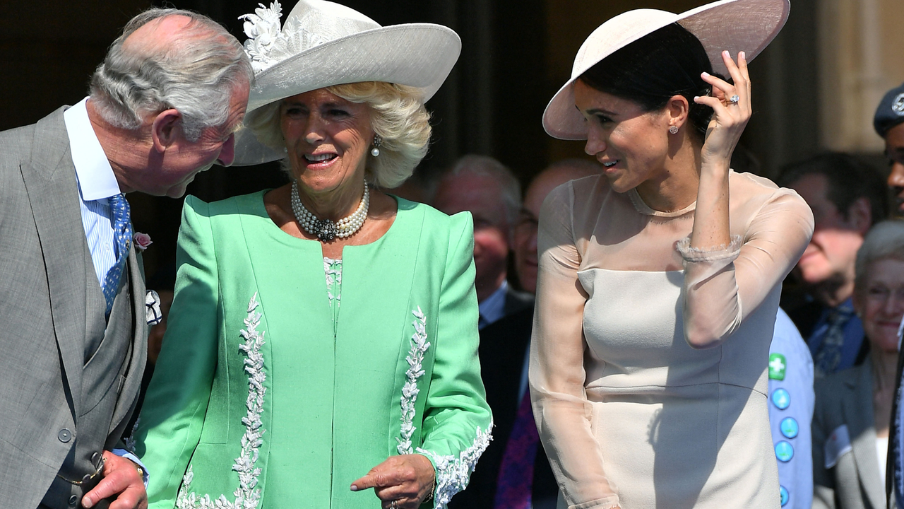 Britain&#039;s Prince Charles, Prince of Wales (L) and his wife Britain&#039;s Camilla, Duchess of Cornwall (C), talk with Britain&#039;s Meghan, Duchess of Sussex, as her husband Britain&#039;s Prince Harry, Duke of Sussex (unseen), speaks during the Prince of Wales&#039;s 70th Birthday Garden Party at Buckingham Palace in London on May 22, 2018. - The Prince of Wales and The Duchess of Cornwall hosted a Garden Party to celebrate the work of The Prince&#039;s Charities in the year of Prince Charles&#039;s 70th Birthday. 